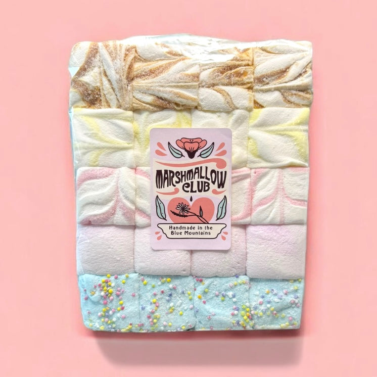 Packaged marshmallows with Marshmallow Club label on a pink background