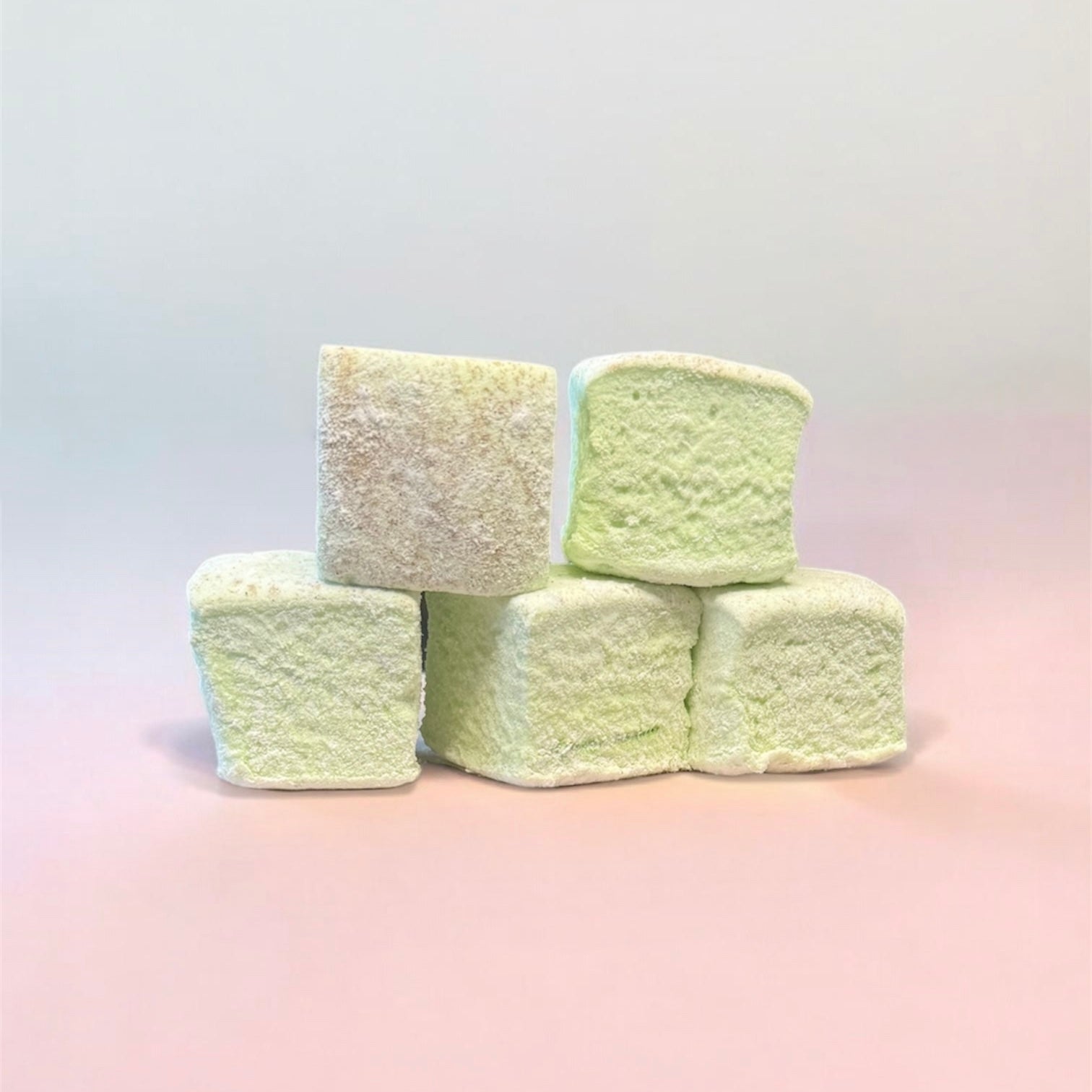 Stack of light green marshmallows on a gradient background