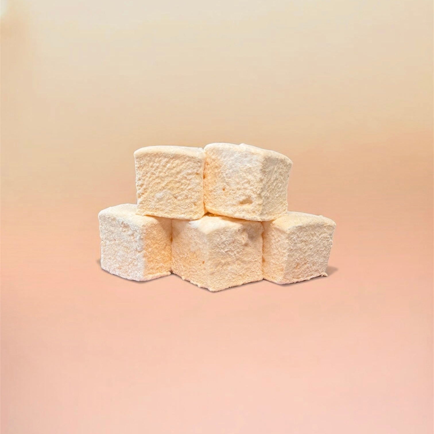 Stack of orange marshmallows on a beige background