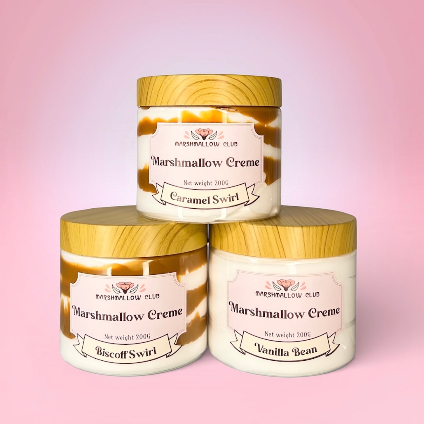 Three jars of Marshmallow Creme with different flavors on a pink background